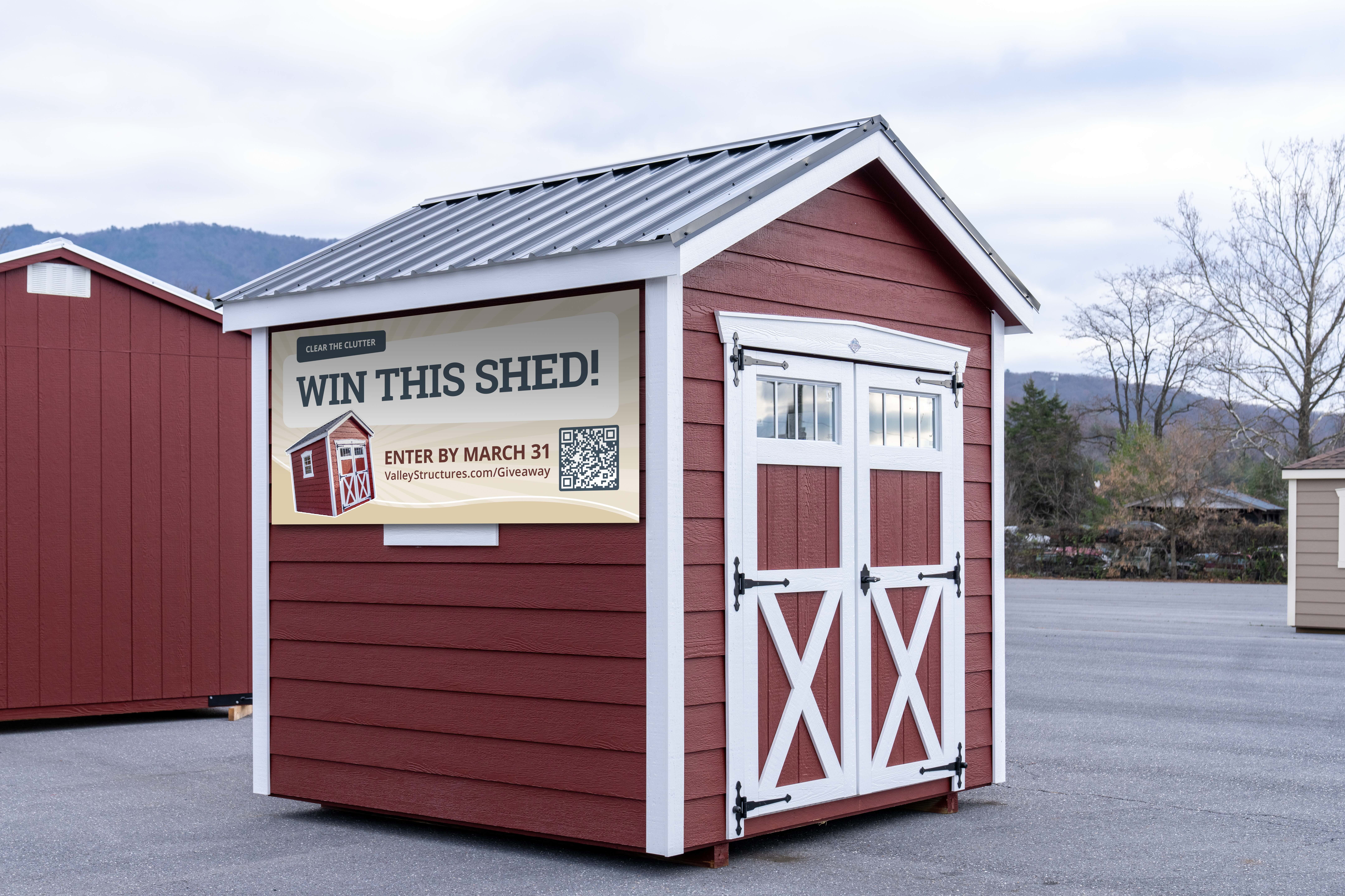 Social media giveaway banner on side of red shed that reads