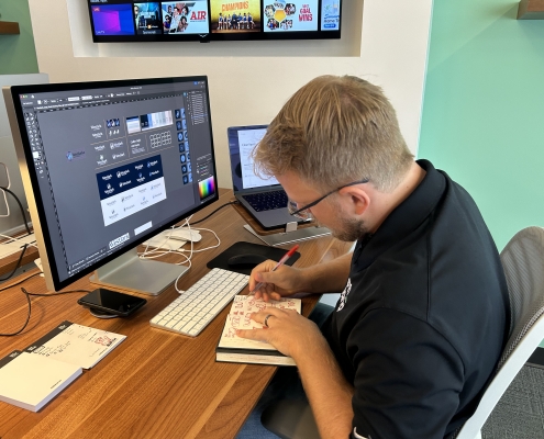 Austin Working on Logos For July 2025 Blog Piece