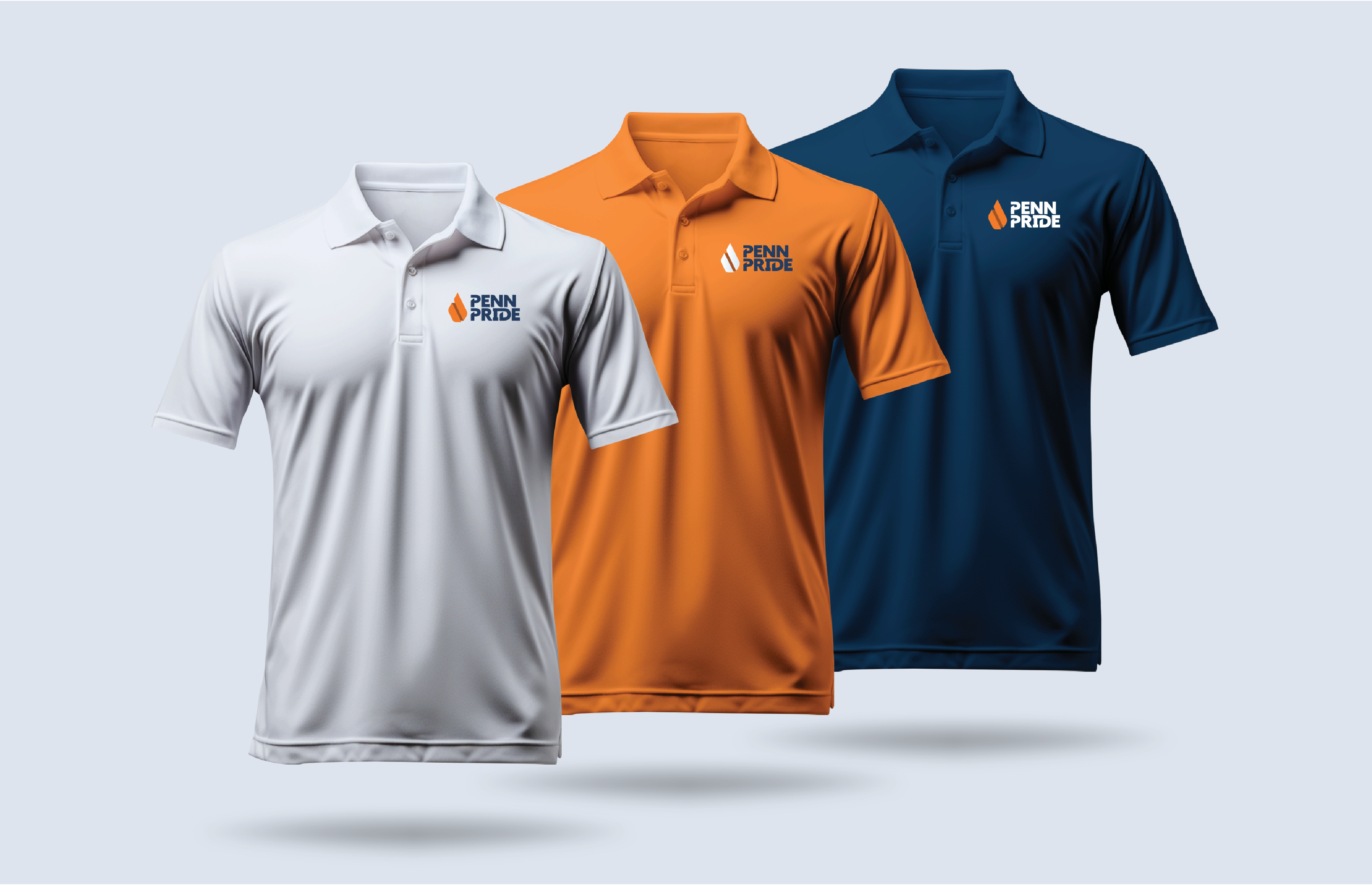Three polos in white, orange and navy with the new Penn Pride logo.