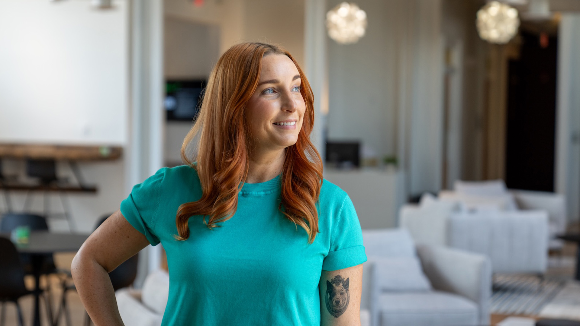 Lauren Stroop, Estland's Marketing Assistant, posing for a photo in the Harrisonburg Innovation Hub lobby.